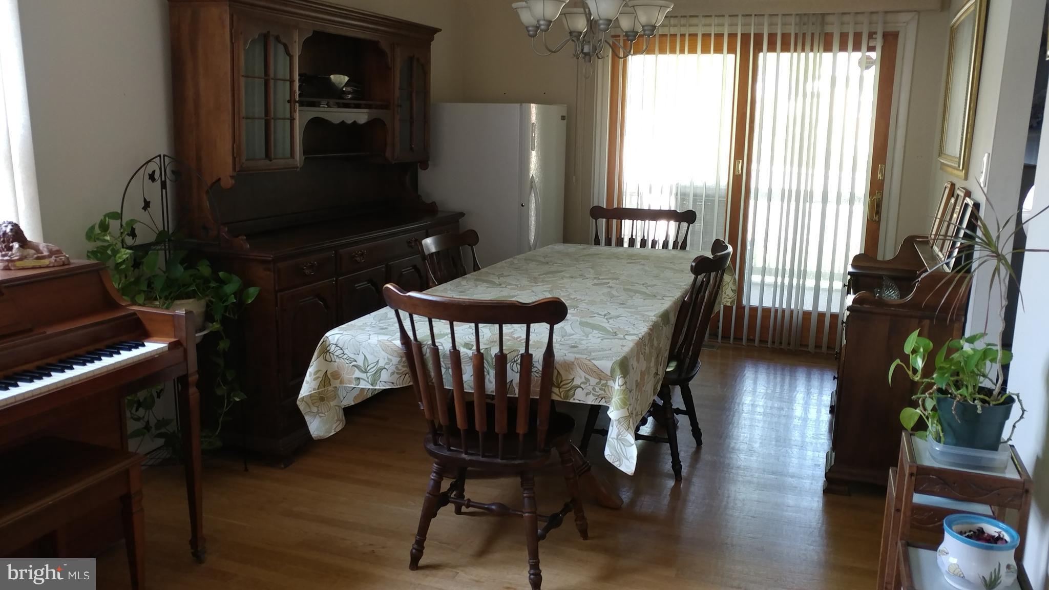 6002 Chesworth Road Baltimore, MD 21228 - Photo 5 of 26 a dining room with furniture and wooden floor