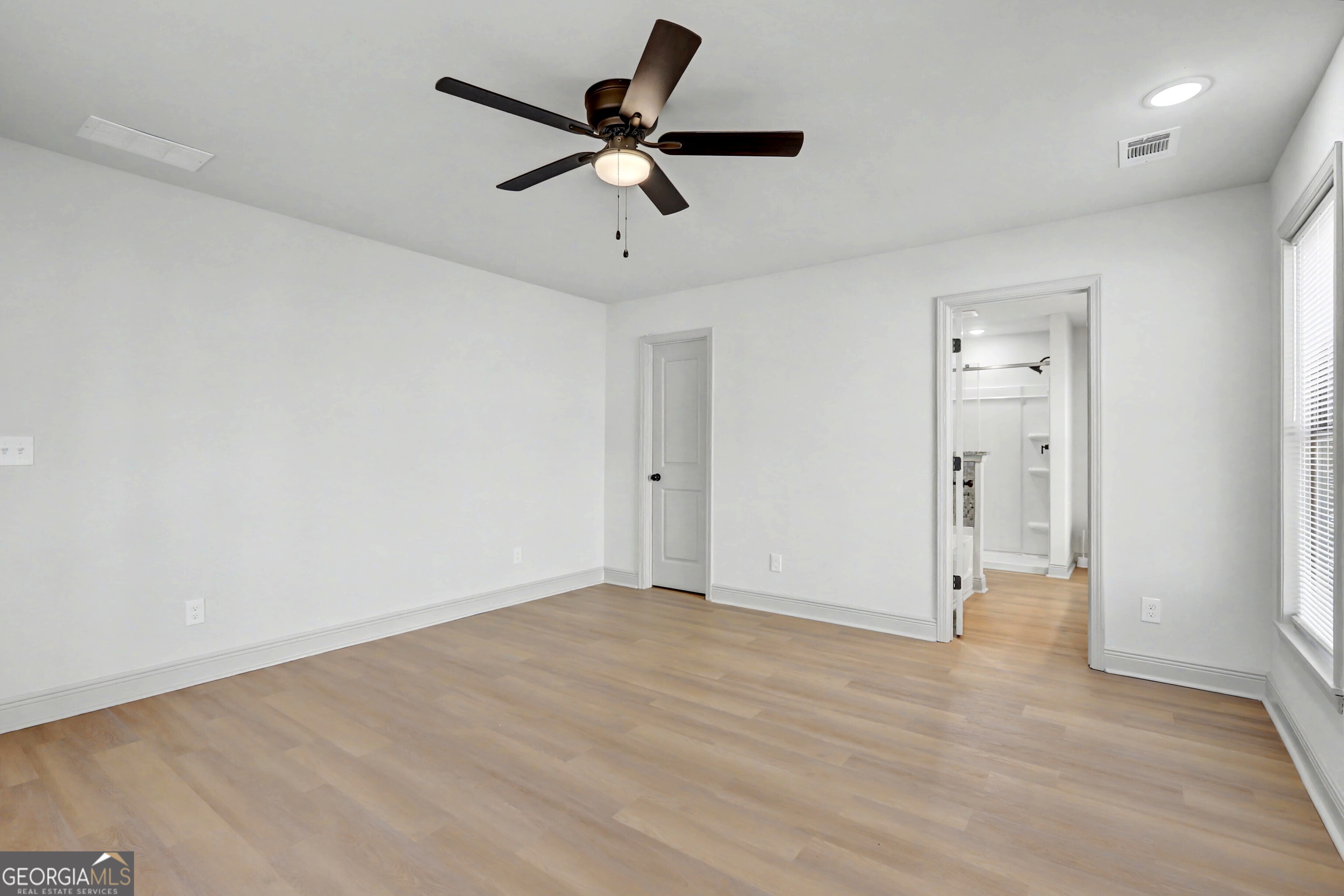 411 Loblolly Ridge Locust Grove, GA 30248 - Photo 12 of 43 an empty room with closet and a ceiling fan