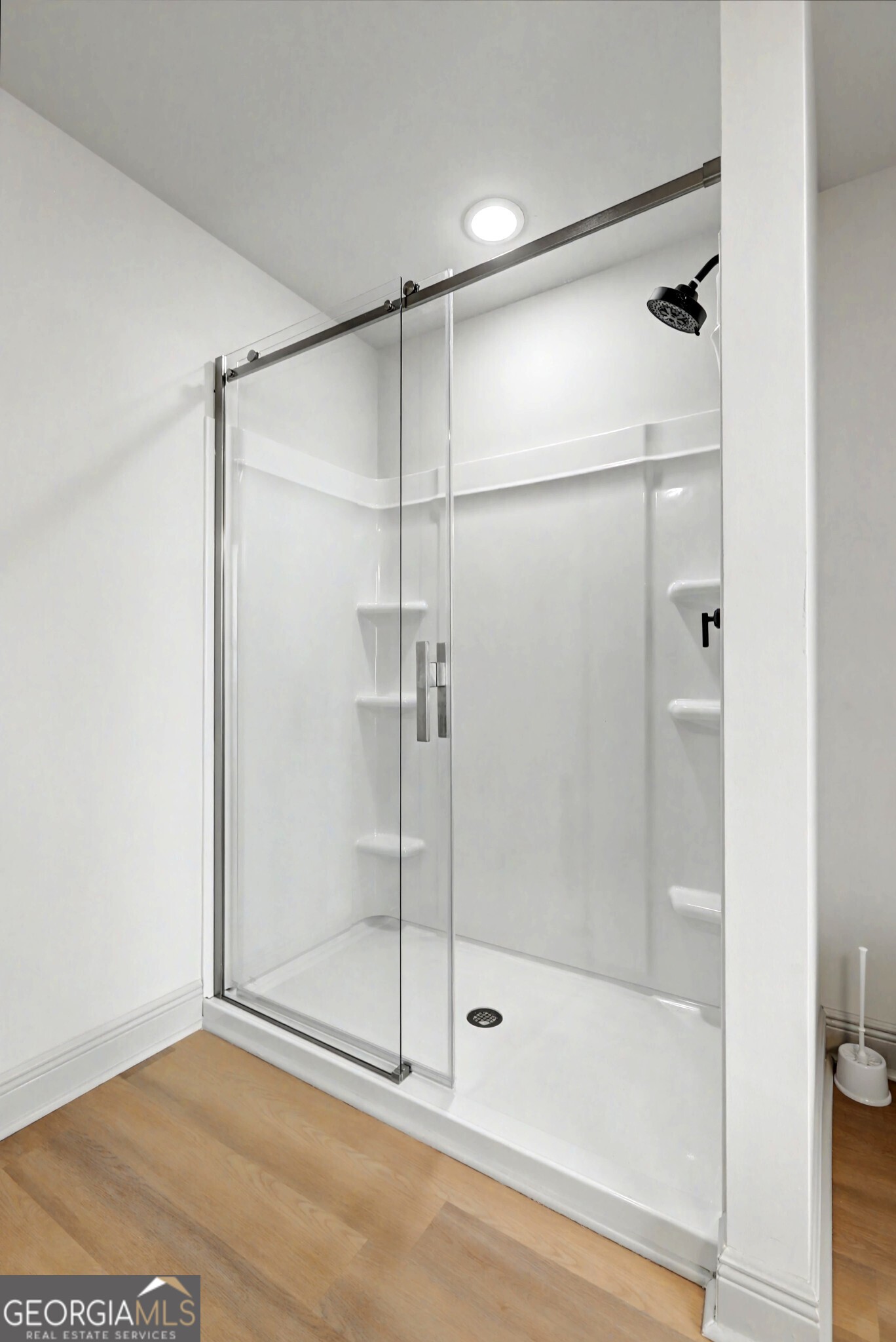 411 Loblolly Ridge Locust Grove, GA 30248 - Photo 16 of 43 a bathroom with a glass shower door