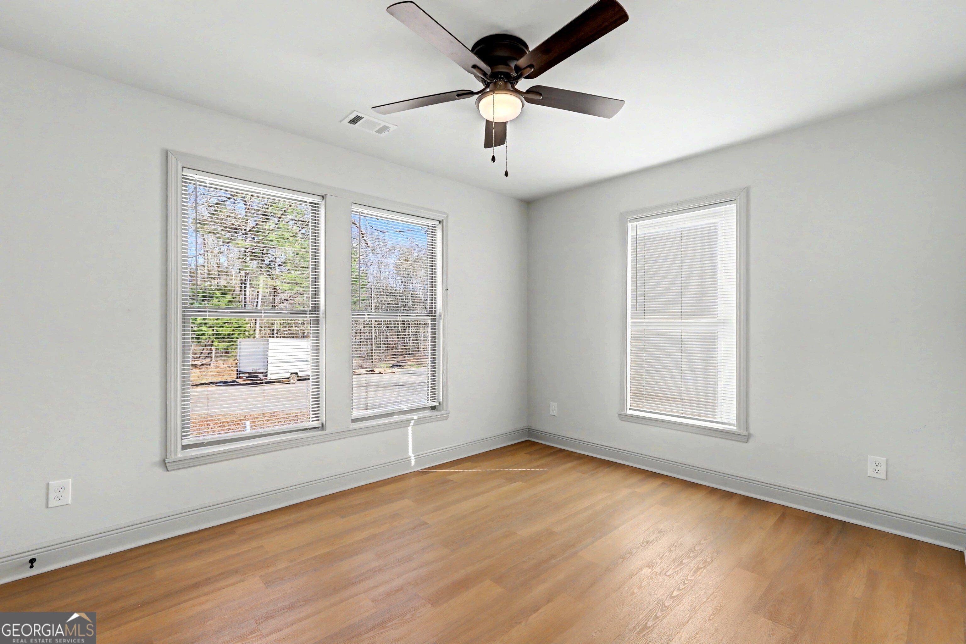 411 Loblolly Ridge Locust Grove, GA 30248 - Photo 19 of 43 a view of an empty room with wooden floor and a window
