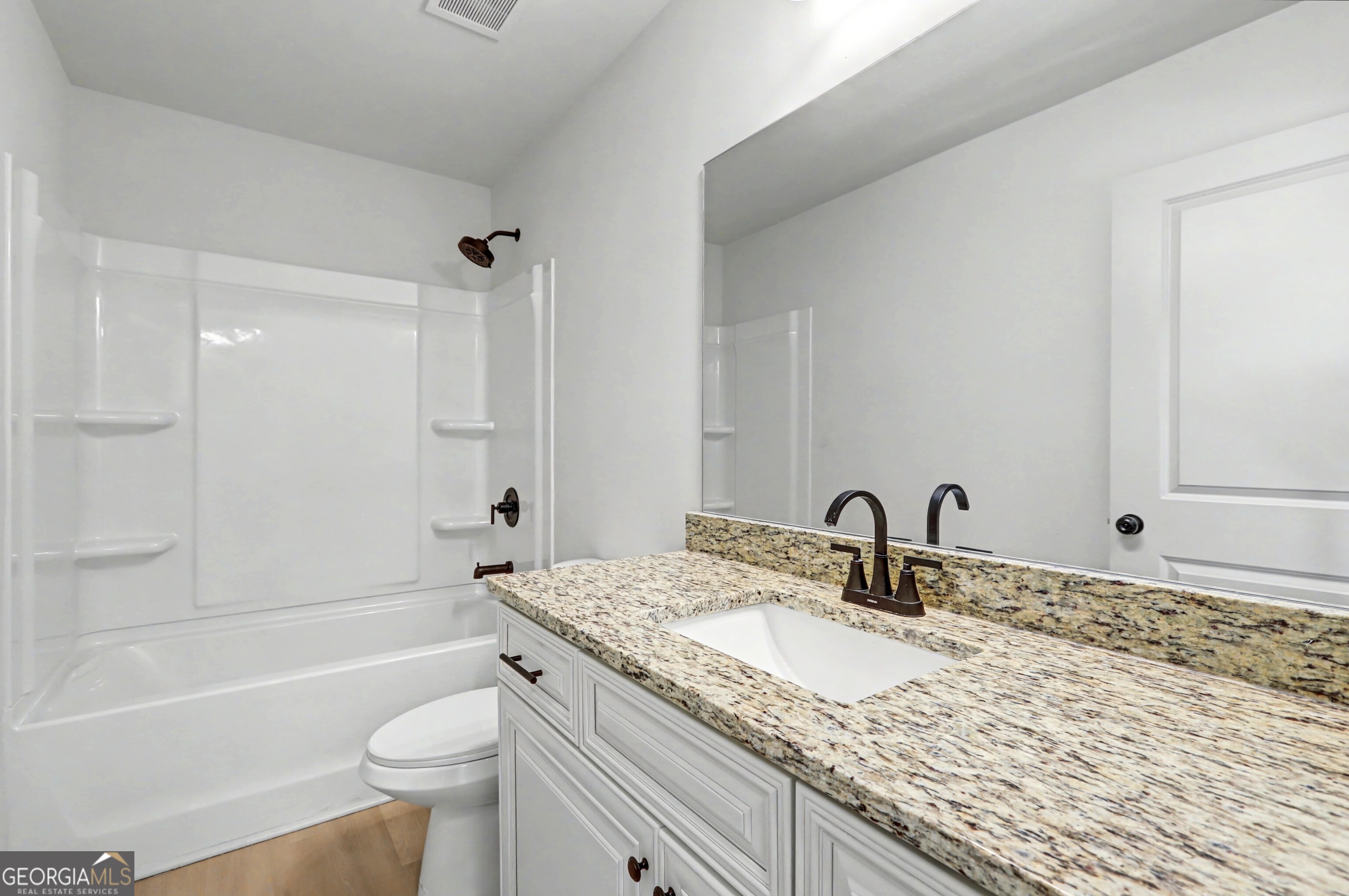 411 Loblolly Ridge Locust Grove, GA 30248 - Photo 24 of 43 a bathroom with a granite countertop sink toilet and shower