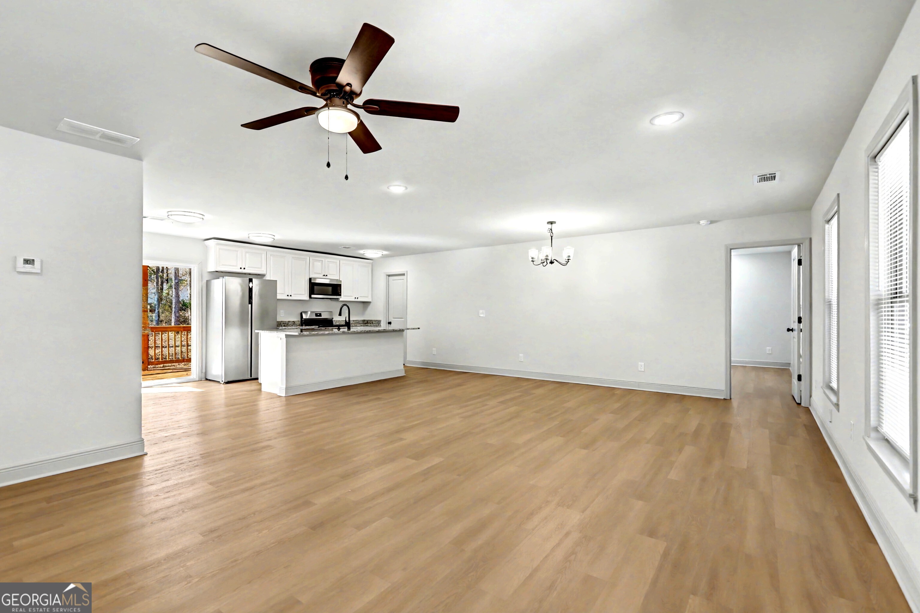 411 Loblolly Ridge Locust Grove, GA 30248 - Photo 3 of 43 a view of empty room with wooden floor and ceiling fan