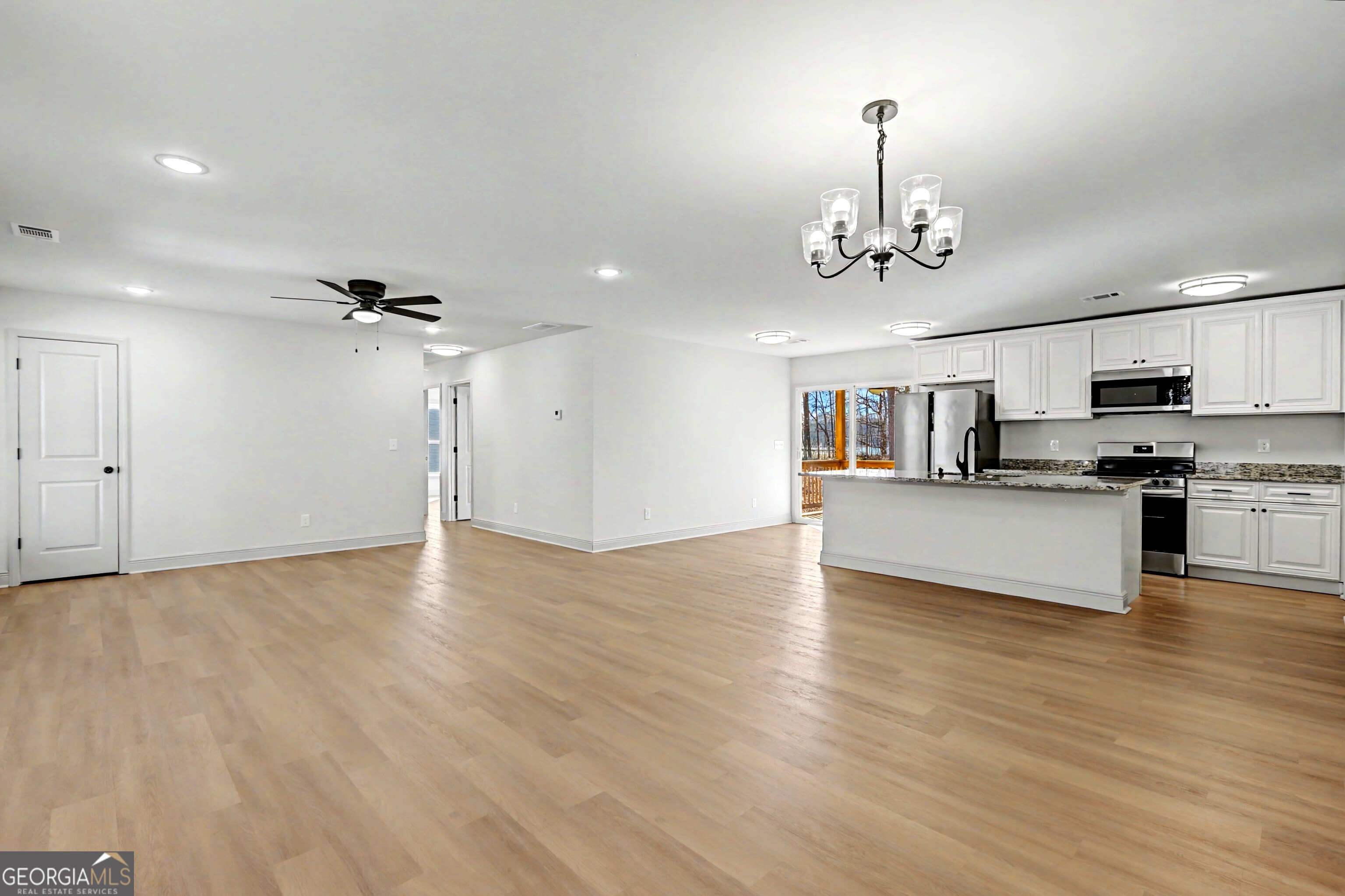 411 Loblolly Ridge Locust Grove, GA 30248 - Photo 4 of 43 a view of kitchen with sink microwave and cabinets