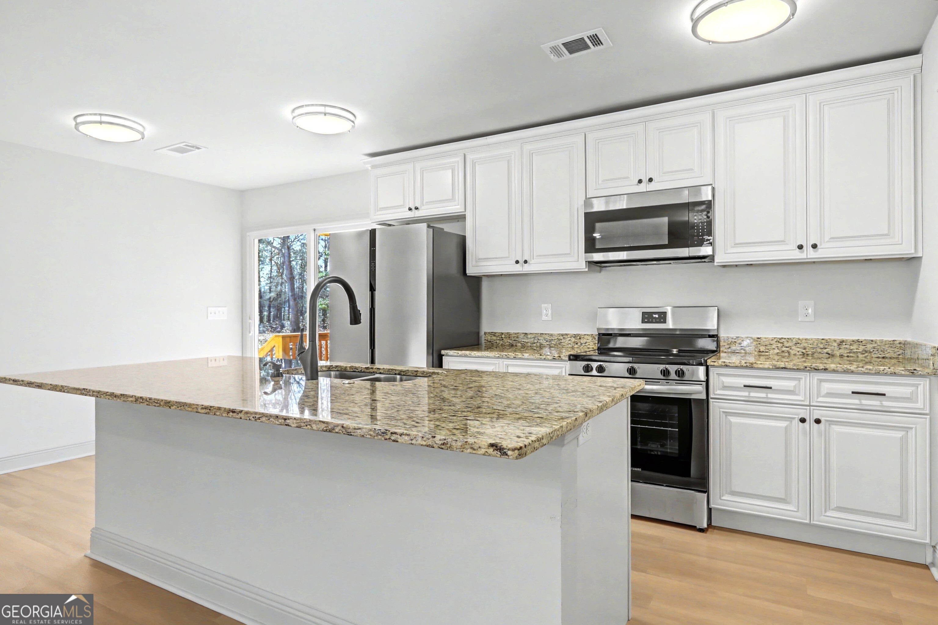 411 Loblolly Ridge Locust Grove, GA 30248 - Photo 6 of 43 a kitchen with stainless steel appliances granite countertop a stove a sink dishwasher and a refrigerator