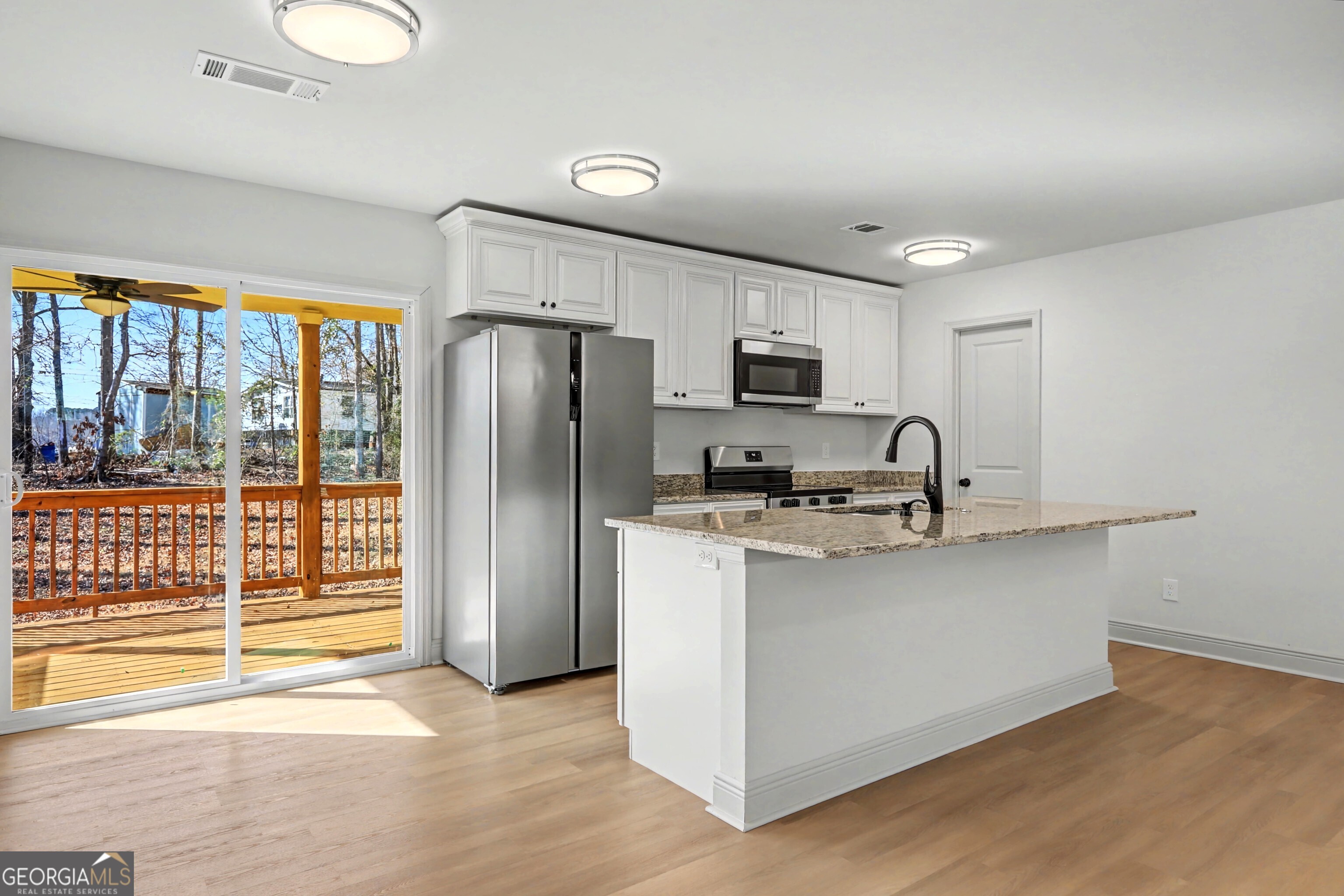 411 Loblolly Ridge Locust Grove, GA 30248 - Photo 7 of 43 a kitchen with stainless steel appliances a refrigerator stove microwave and sink
