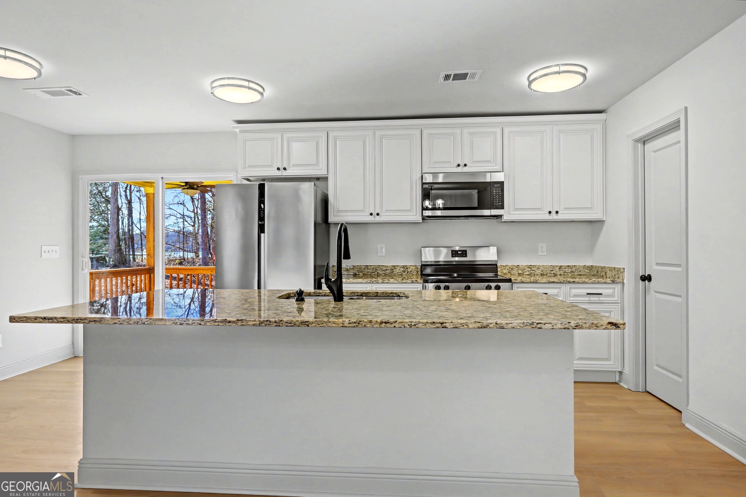 411 Loblolly Ridge Locust Grove, GA 30248 - Photo 9 of 43 a kitchen with stainless steel appliances granite countertop a refrigerator a stove and a sink