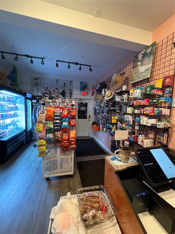 491 Dock Street Cedar Key, FL 32625 - Photo 19 of 22 a room with lots of different furniture and a wooden floor