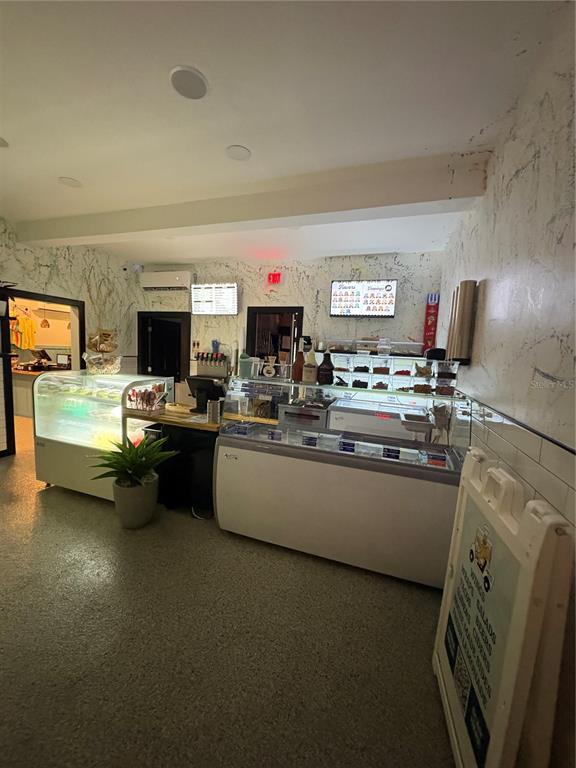 491 Dock Street Cedar Key, FL 32625 - Photo 20 of 22 a living room with stainless steel appliances kitchen island granite countertop furniture and a fireplace