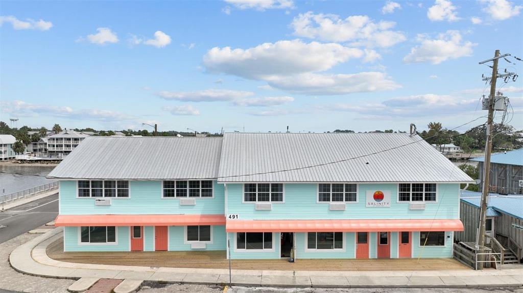 491 Dock Street Cedar Key, FL 32625 - Photo 2 of 22 a view of a large building with a lot of windows