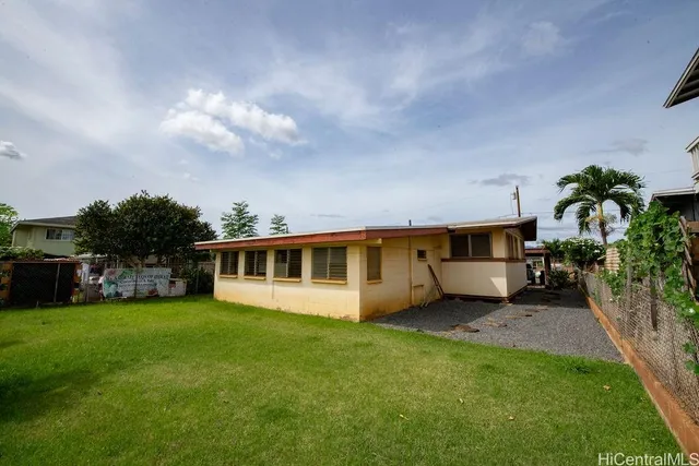 a view of a house with a yard and sitting area