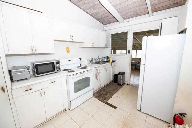 a kitchen with a stove a sink and a refrigerator
