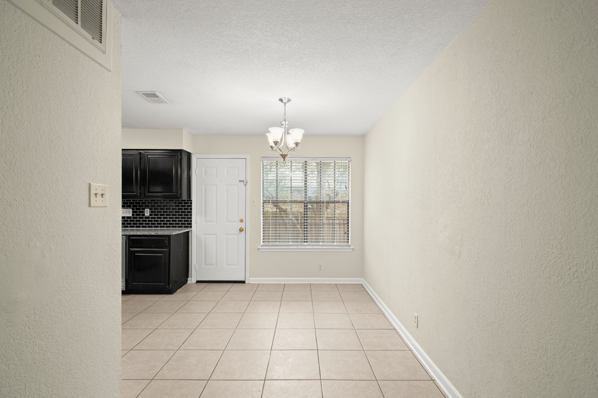 3801 Foust Trail, Unit B Georgetown, TX 78628 - Photo 12 of 31 Open space featuring light-colored tile flooring, a window with blinds, and a light fixture