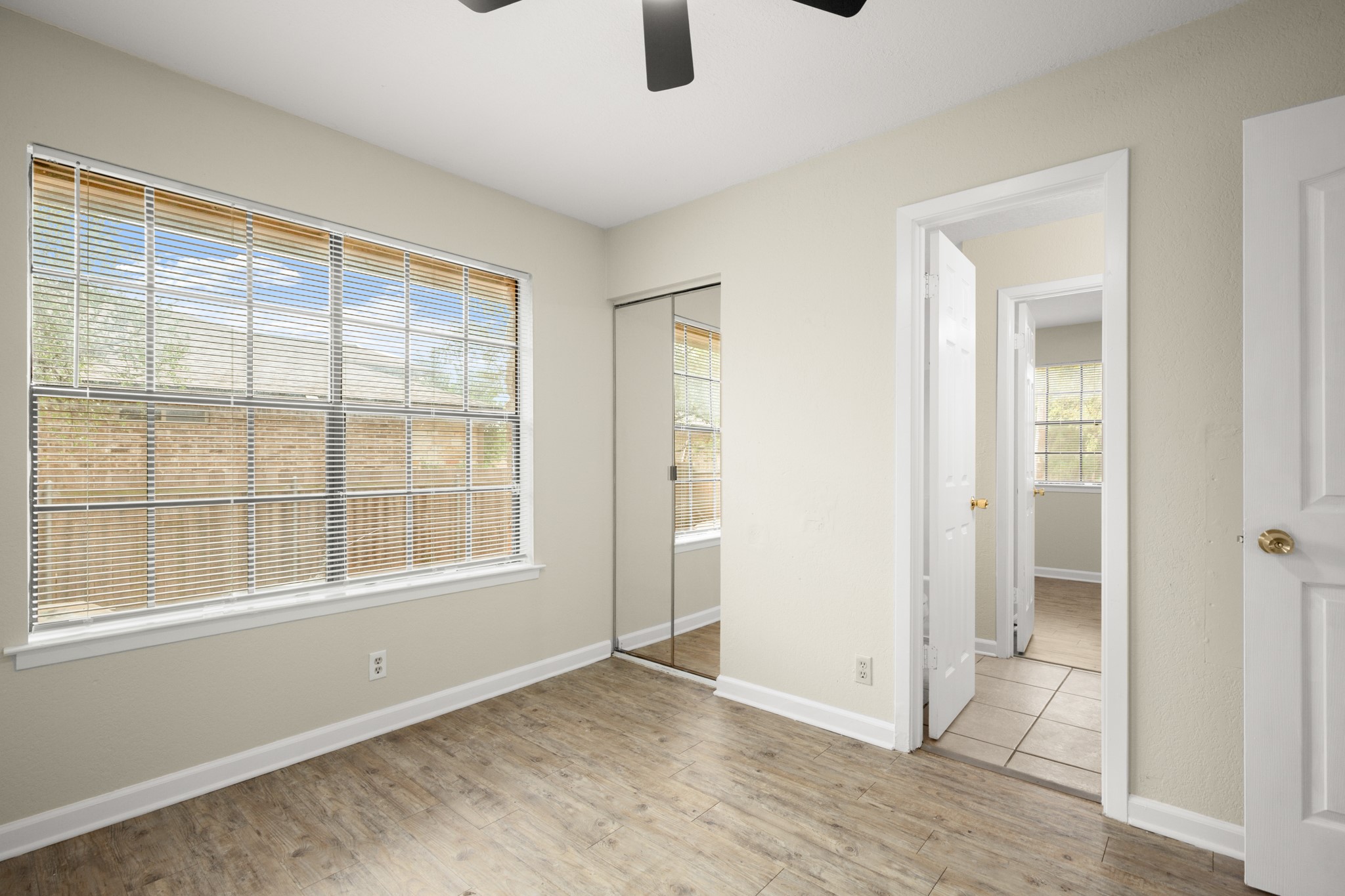3801 Foust Trail, Unit B Georgetown, TX 78628 - Photo 13 of 31 This room features light-toned walls, wood-look flooring, and a large window with horizontal blinds