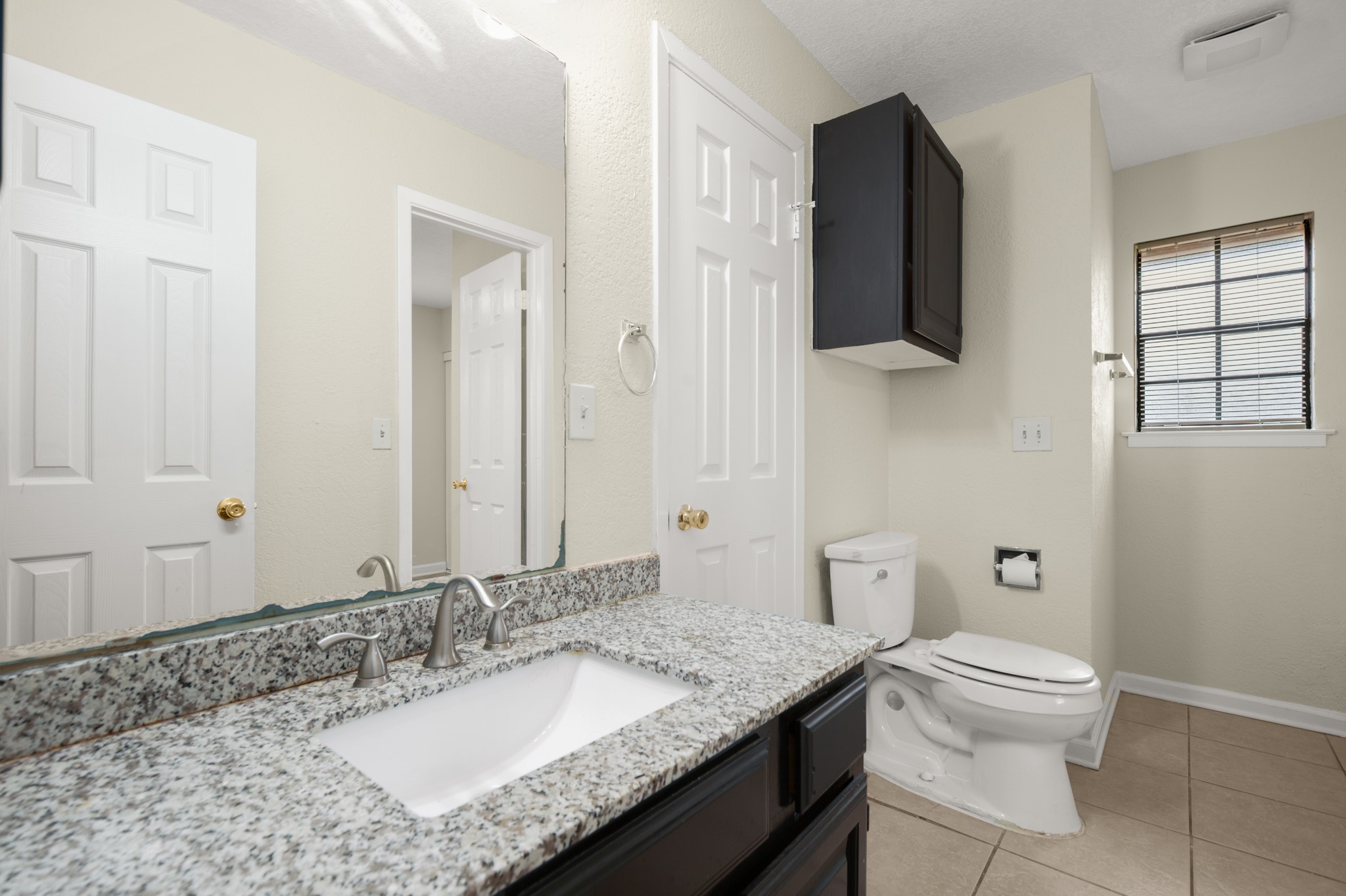 3801 Foust Trail, Unit B Georgetown, TX 78628 - Photo 17 of 31 Bathroom featuring a vanity with a granite countertop, an undermount sink, and a dark cabinet