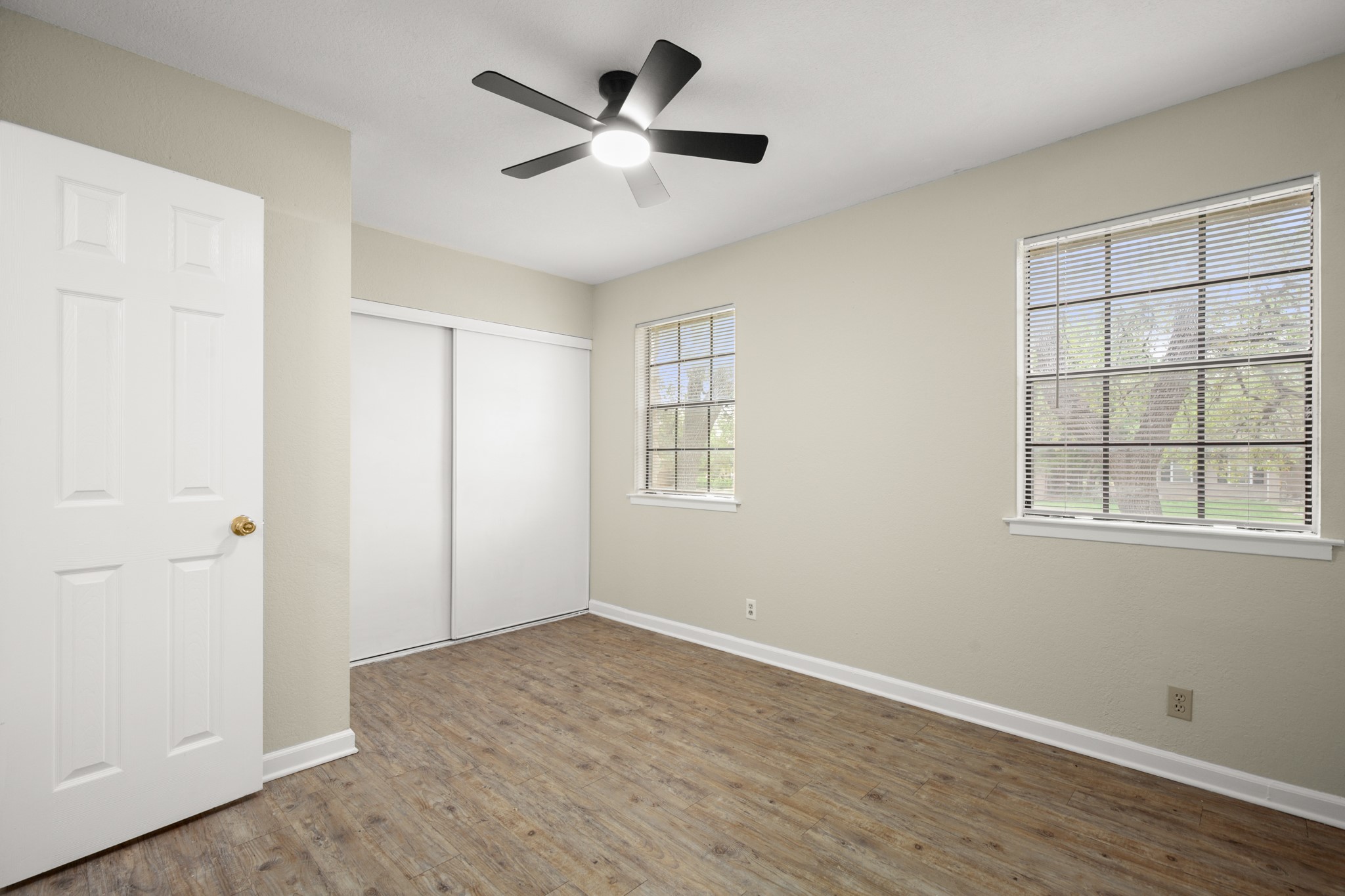 3801 Foust Trail, Unit B Georgetown, TX 78628 - Photo 19 of 31 Room featuring wood-look flooring, light-colored walls, and a ceiling fan with integrated lighting