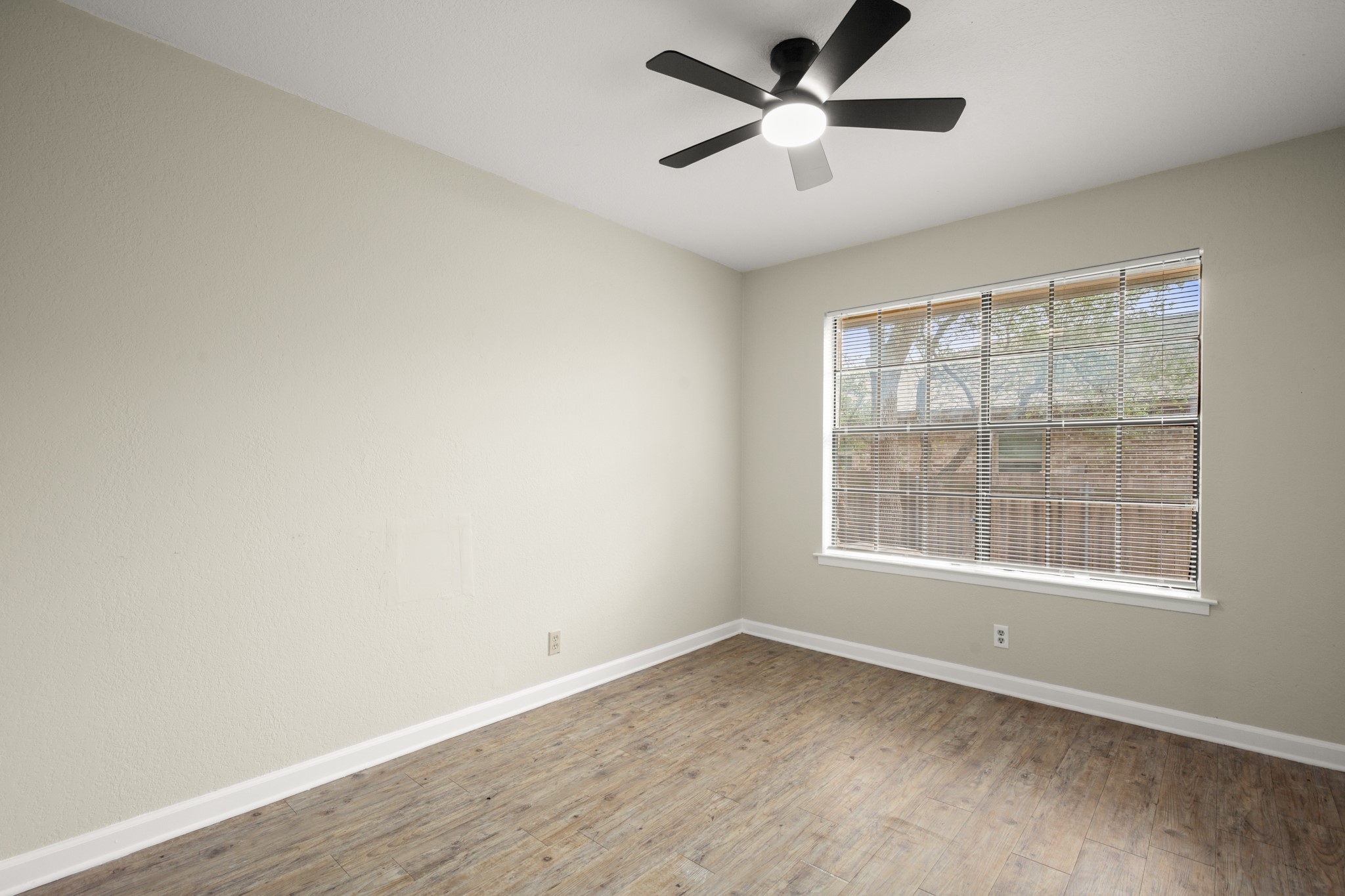 3801 Foust Trail, Unit B Georgetown, TX 78628 - Photo 21 of 31 This room features wood-look flooring, light-toned walls, and a window with blinds