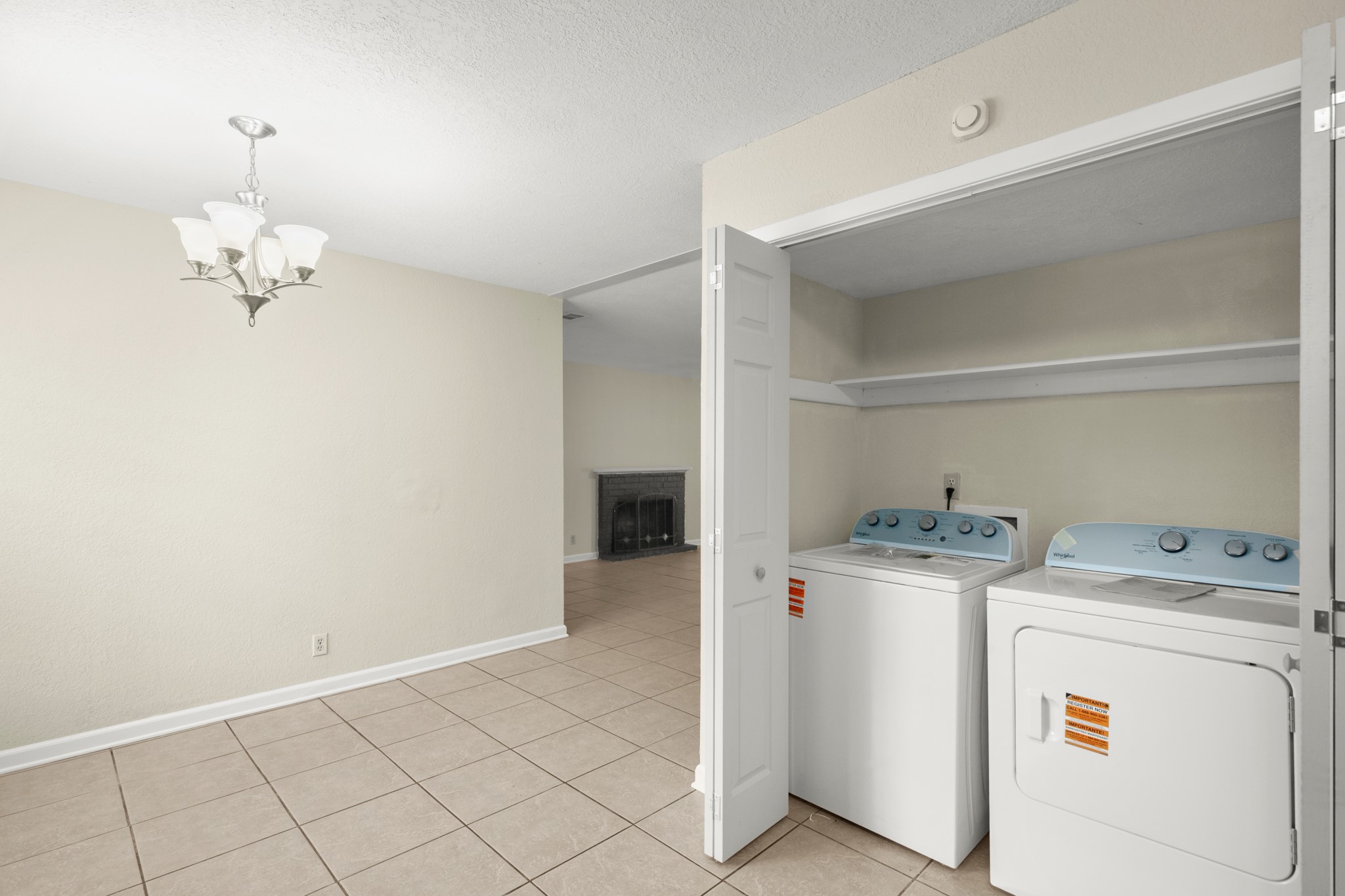 3801 Foust Trail, Unit B Georgetown, TX 78628 - Photo 7 of 31 This property features a laundry area with a washer and dryer, convenient shelving, and tile flooring