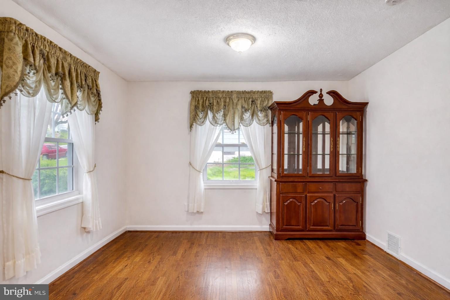 12304 Charles Road Silver Spring, MD 20906 - Photo 3 of 14 an empty room with wooden floor closet and windows
