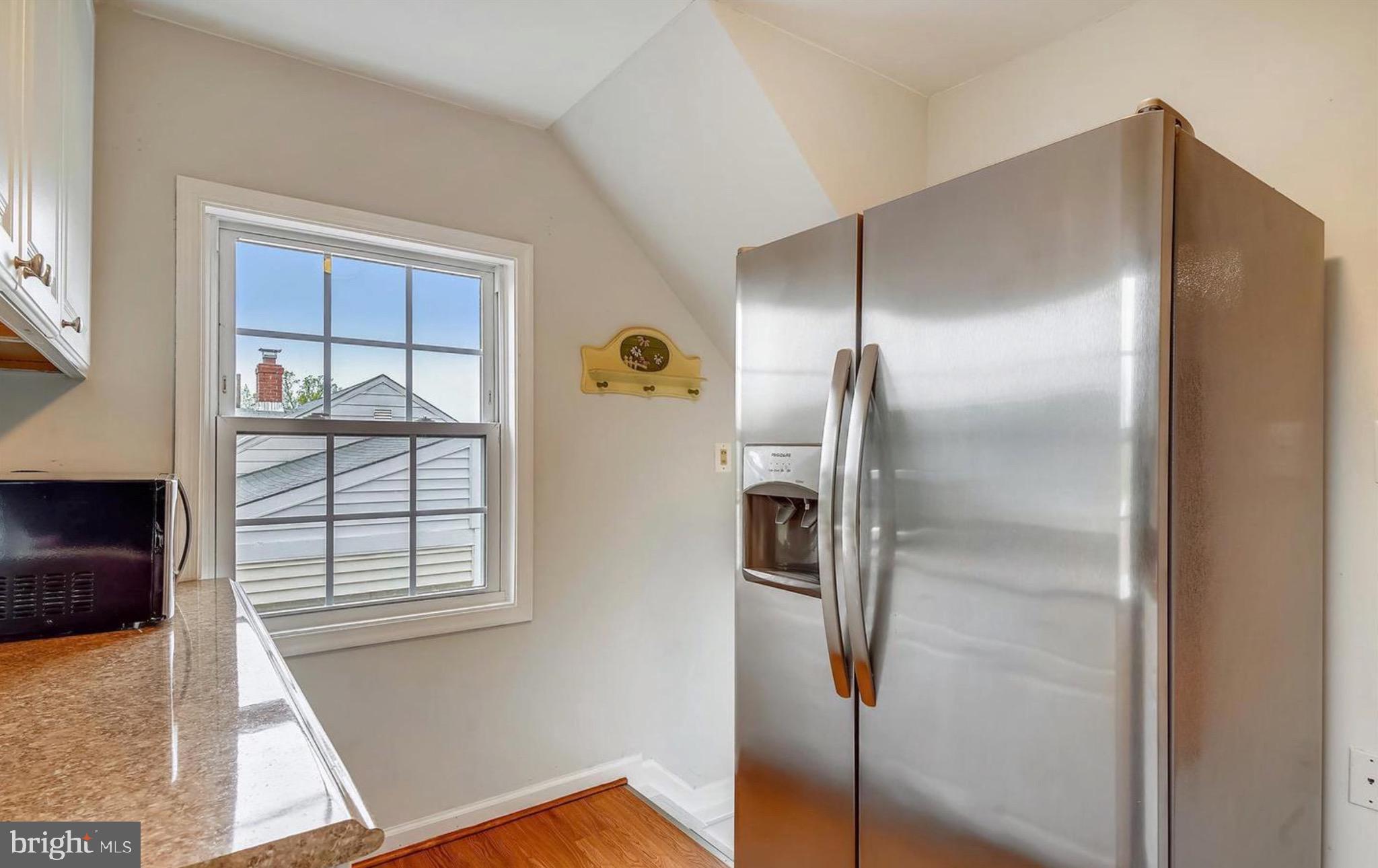 12304 Charles Road Silver Spring, MD 20906 - Photo 5 of 14 a kitchen with a refrigerator and window