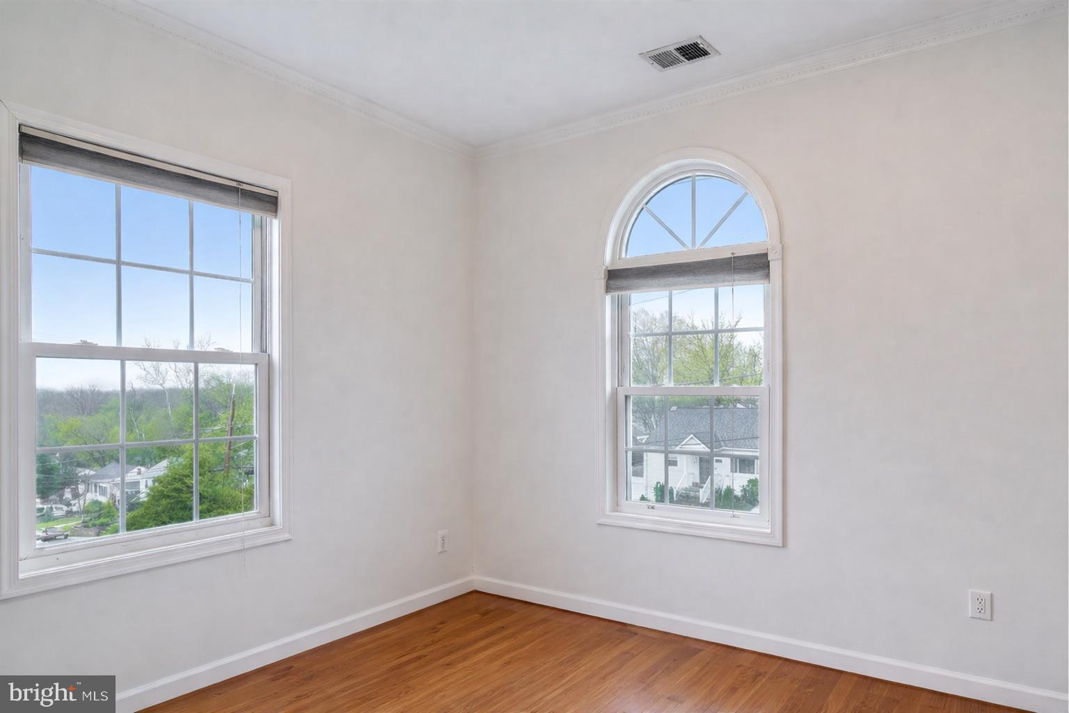 12304 Charles Road Silver Spring, MD 20906 - Photo 6 of 14 an empty room with wooden floor and windows