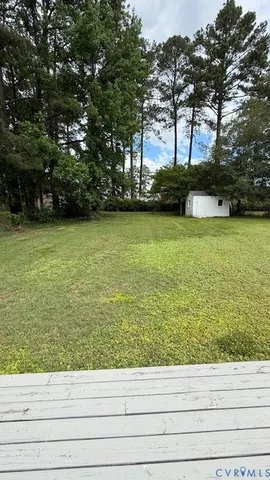 a view of a house with a yard and sitting area