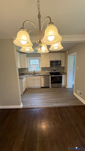 9014 Weldon Drive Henrico, VA 23229 - Photo 6 of 24 a kitchen with kitchen island a stove and a wooden floors