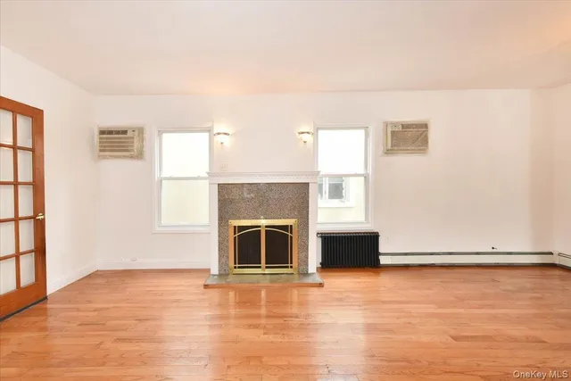 a living room with hard wood floors and a fireplace