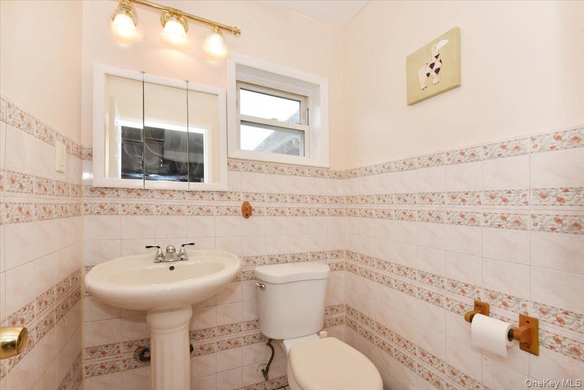 81-35 166th Street Queens, NY 11432 - Photo 16 of 34 a bathroom with a sink and a toilet