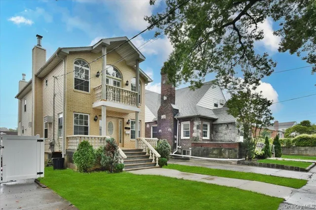 a front view of house with yard and green space