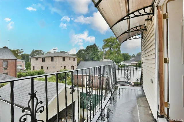 a view of a balcony with wooden floor and stairs