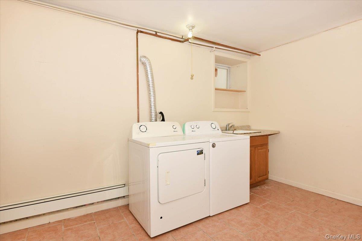 81-35 166th Street Queens, NY 11432 - Photo 32 of 34 a utility room with dryer and washer
