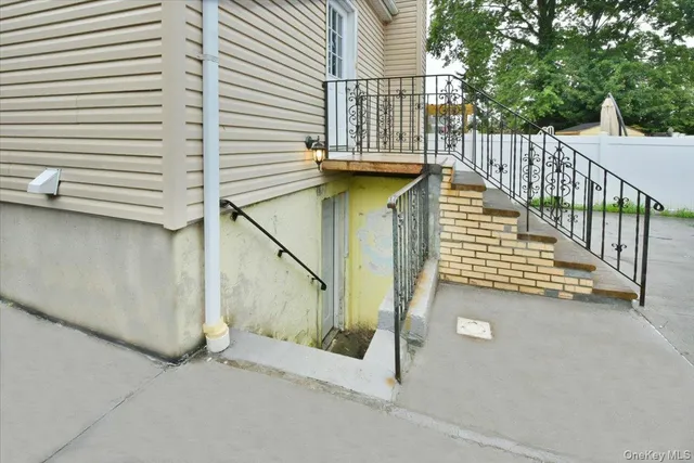 a view of a balcony with wooden floor and iron fence