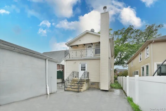 a view of a house with more windows and a small yard