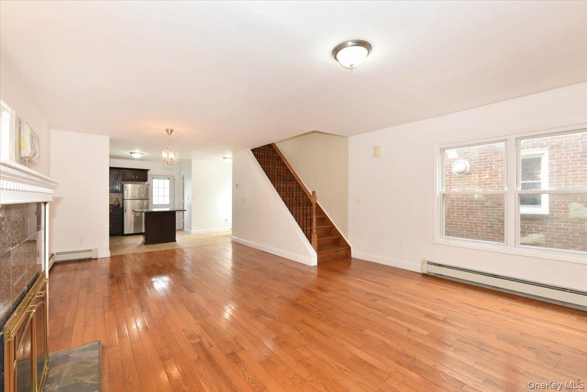 81-35 166th Street Queens, NY 11432 - Photo 10 of 34 a view of an empty room with wooden floor and a window
