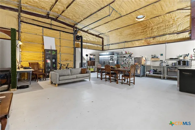 a living room with lots of furniture and a chandelier