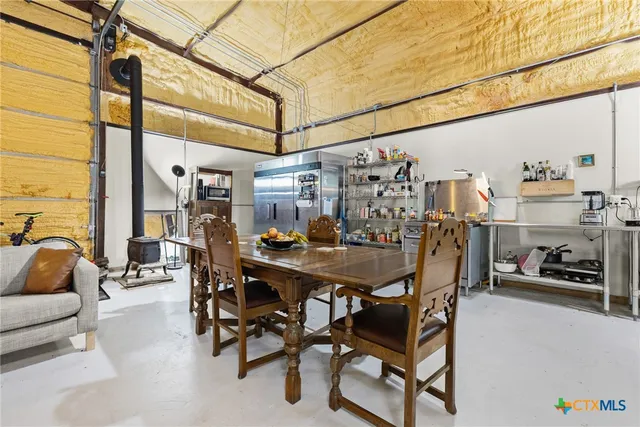 a view of a dining room with furniture and a chandelier