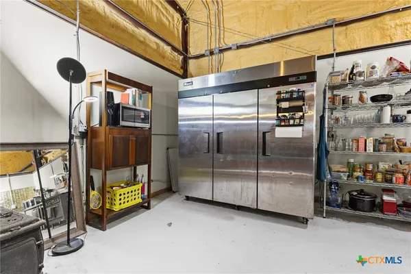 a kitchen with refrigerator and window