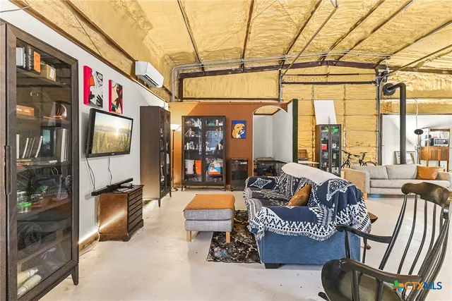 a living room with furniture and a floor to ceiling window