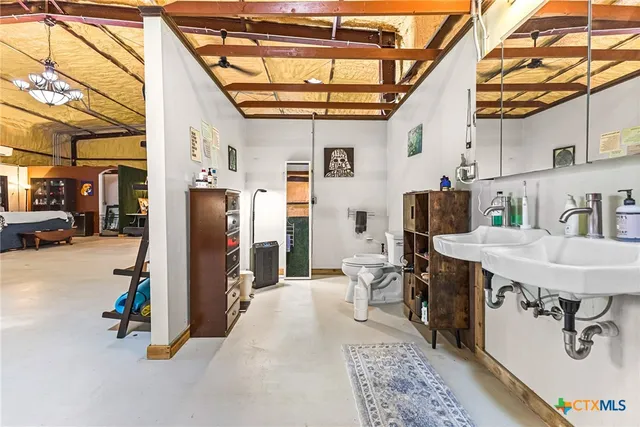a view of a kitchen with furniture and a refrigerator