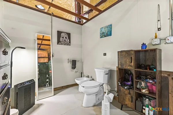 a bathroom with a toilet and a shower