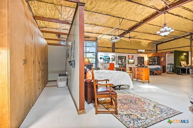 a view of a livingroom with workspace and a window