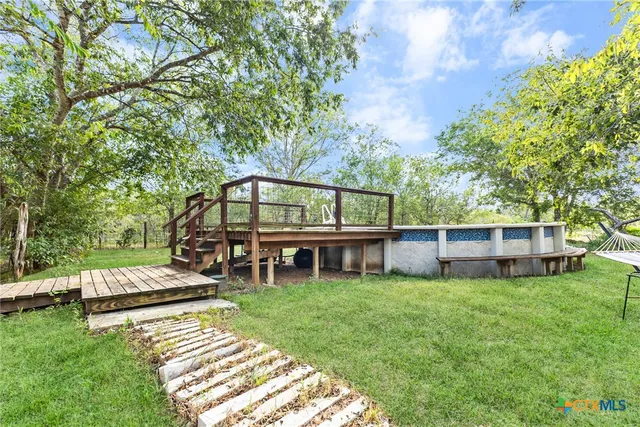 a view of a wooden deck with a yard