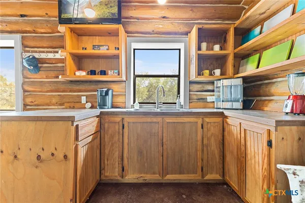 a bathroom with a window and a shower