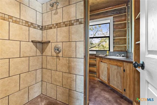 a bathroom with a sink toilet and window