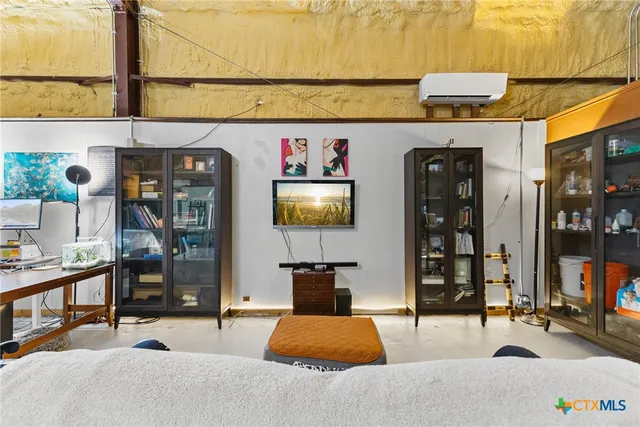 a living room with furniture a flat screen tv and potted plant