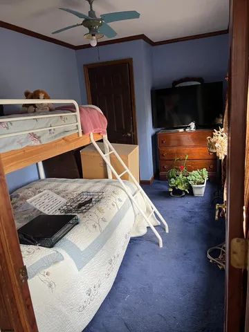 a bedroom with a bed and a flat tv screen