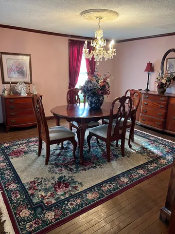 a view of a dining room with furniture and chandelier