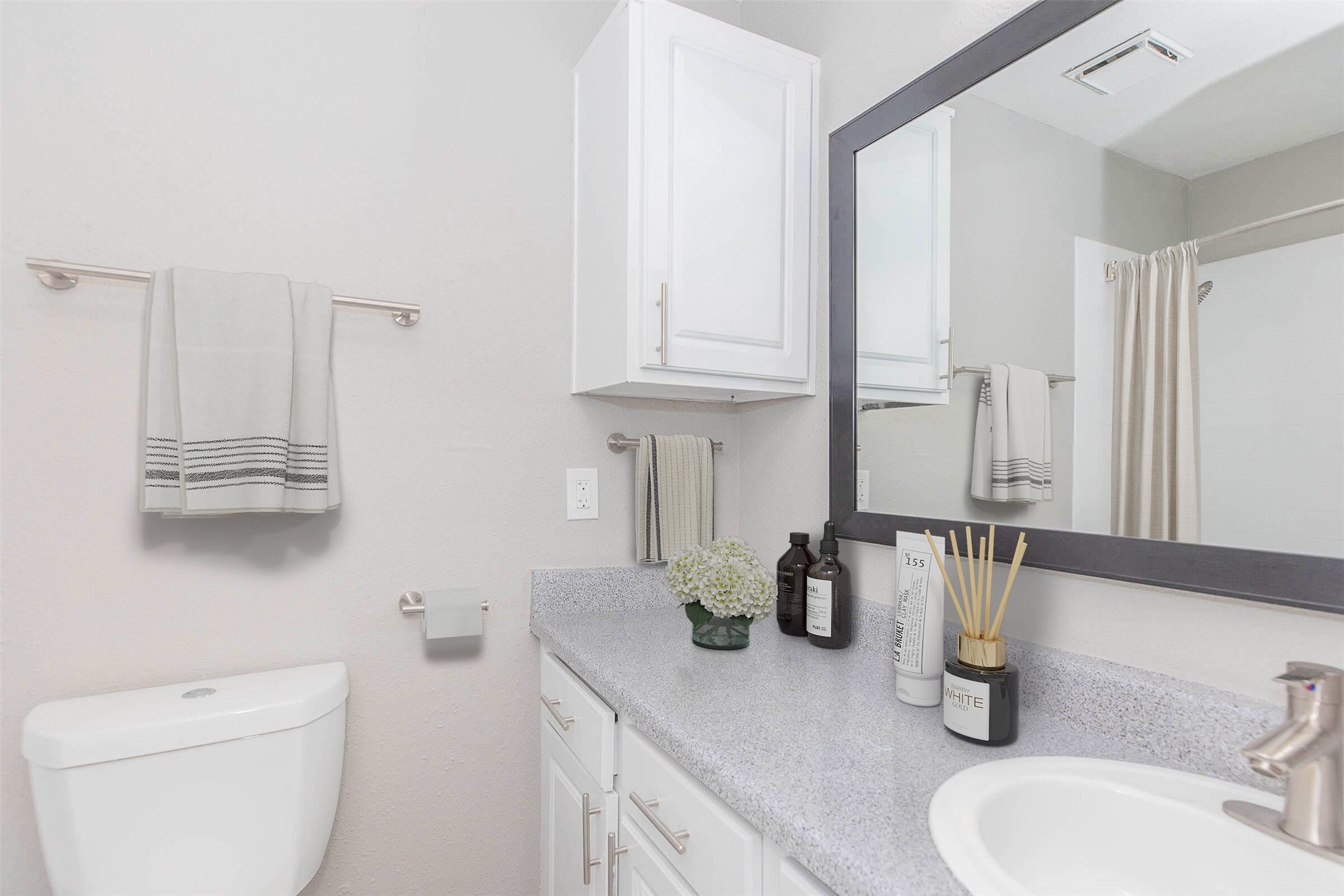 21717 Inverness Forest Boulevard, Unit 2604 Houston, TX 77073 - Photo 6 of 29 a bathroom with a sink a toilet and mirror