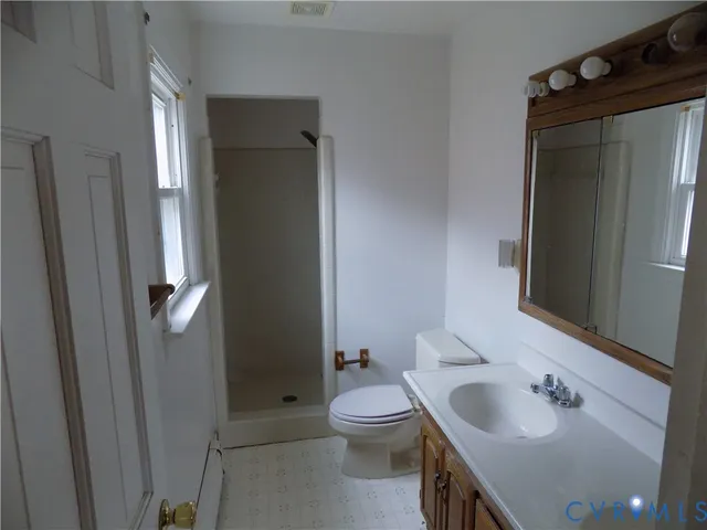 a bathroom with a toilet sink and shower