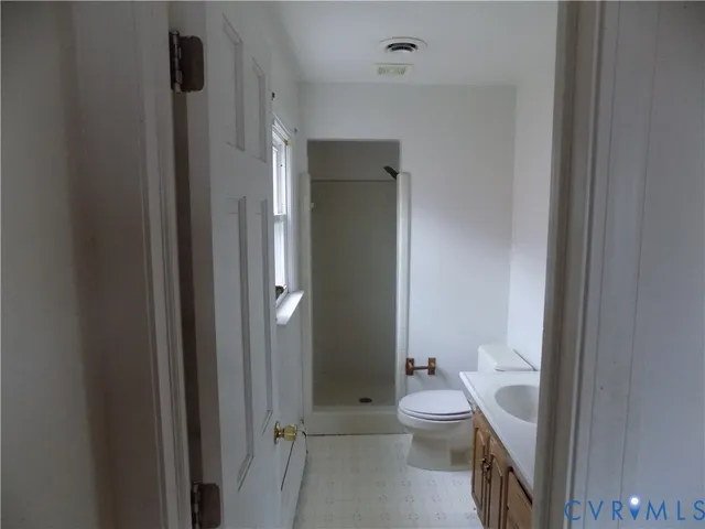 a bathroom with a toilet a sink and shower